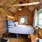 Greenhill glampings Kingsize bed with views out to the meadow.