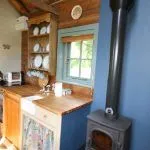 Kitchen area and woodstove at our Shepherds hut |Greenhill Glamping